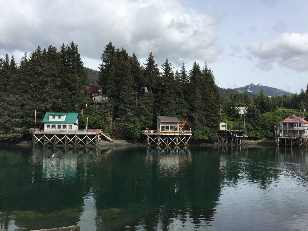 Stilted cabins overlooking a calm water inlet in Seldovia, Alaska