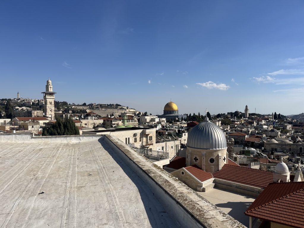 Rooftop view of Jerusalem’s Old City with the Dome of the Rock in the background.